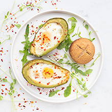 breakfast in the ketogenic box diet - eggs with chili pepper flakes baked in avocado, dry keto muffin